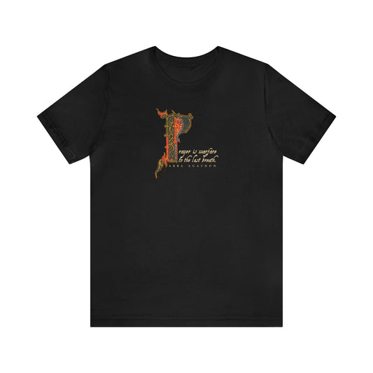Black t-shirt featuring ornate letter P and cursive "Prayer is Warfare to the Last Breath"—a bold Orthodox Christian reminder to persevere in prayer through every spiritual battle.