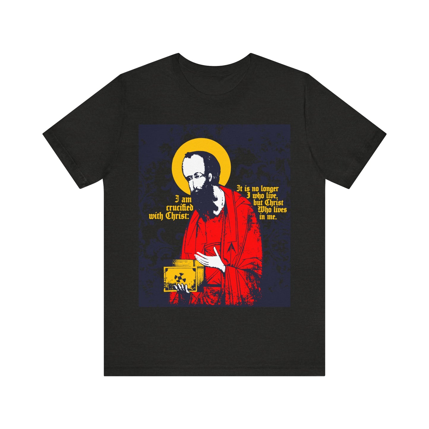 The Black Heather "St Paul Holding Gospel Iconographic" T-shirt features St. Paul with a yellow halo and the text "I am crucified with Christ—Galatians 2:20," expressing new life in Christ.