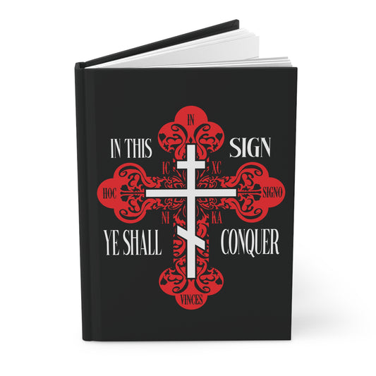 Black hardcover Christian journal featuring a red ornate Orthodox Cross and the text "In This Sign Ye Shall Conquer | In Hoc Signo Vinces | ICXC NIKA | Jesus Christ Conquers." Inspired by the prayer of the Holy Cross.