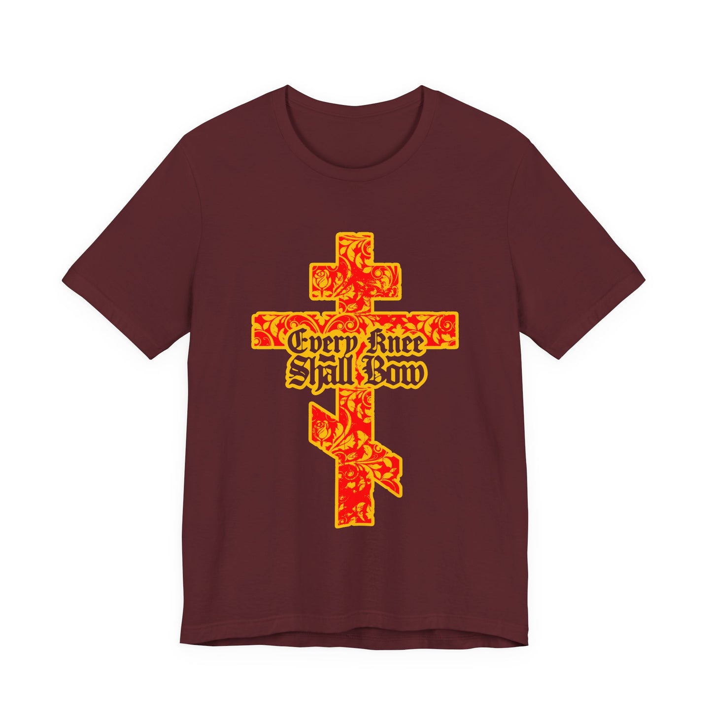 Maroon unisex tee with a gold and red floral-textured Orthodox cross and gothic "Every Knee Shall Bow" text, inspired by Isaiah 45:22-24 and Philippians 2:7-11.
