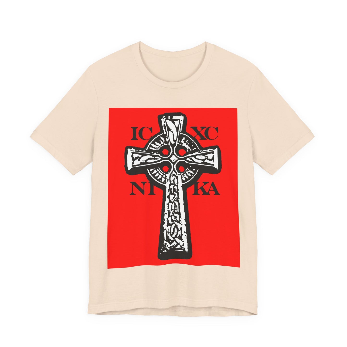 Soft cream T-shirt featuring a bold red square with a black and white ICXC NIKA Celtic knotwork cross and Cyrillic-style "Jesus Christ Conquers" text; traditional Orthodox Christian design.