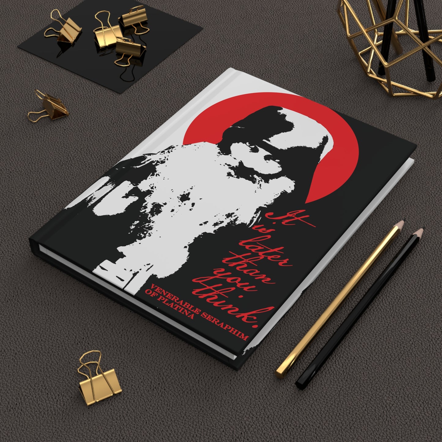 The Remembrance of Death “It’s Later Than You Think | Fr Seraphim Rose” journal features a bold black-and-white cover with Fr. Seraphim Rose, a red halo, and text—a modern Orthodox memento mori for Christian reflection. Pens and clips surround the notebook.