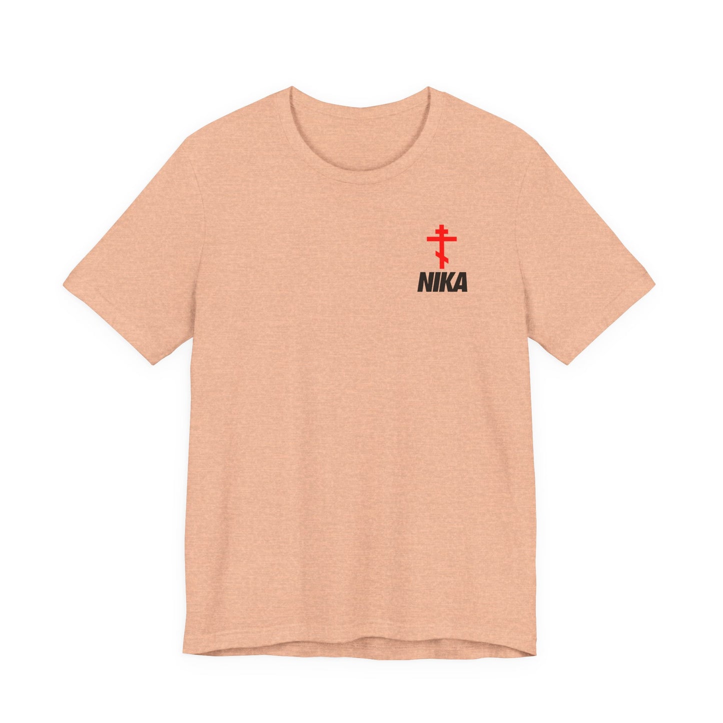 Heather peach t-shirt featuring a small red Orthodox cross and bold NIKA text, inspired by the Nike logo mashup and symbolizing "Jesus Christ Conquers." Perfect for athletic ascetic Christian fashion.