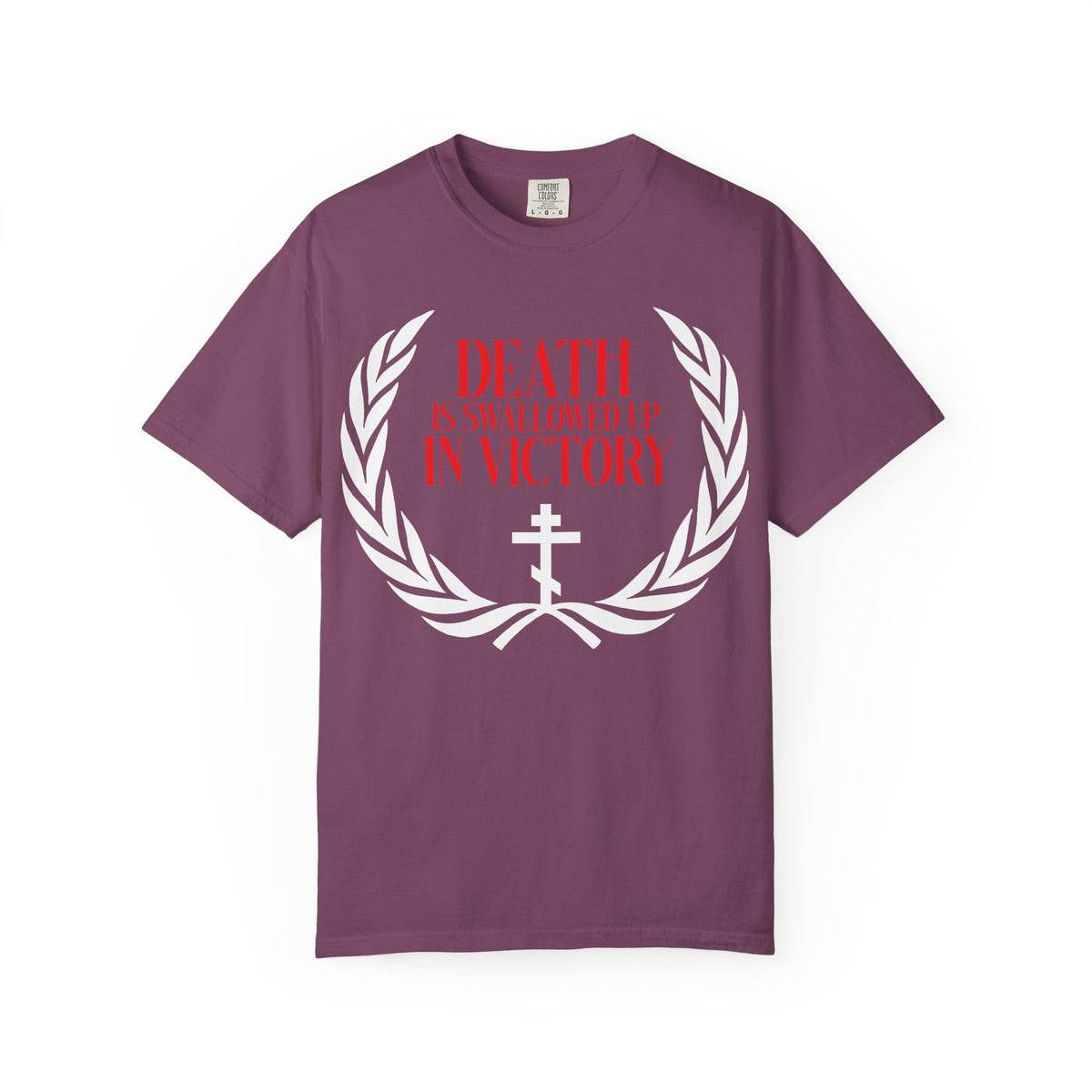 Berry t-shirt featuring a white victory wreath and an Orthodox cross, with bold red text: DEATH IS SWALLOWED UP IN VICTORY (1 Cor 15:54), symbolizing the triumph of immortality over death.