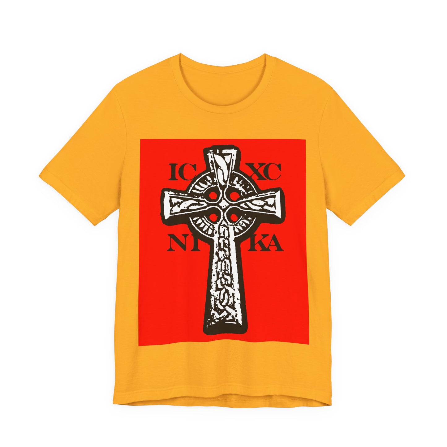Gold t-shirt featuring a large red rectangle with a black and white ICXC NIKA Celtic knotwork cross and Greek letters, symbolizing Jesus Christ conquers—traditional Orthodox Christian design.