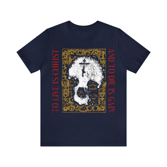 Navy "To Live is Christ, to Die is Gain" t-shirt featuring a white skull and cross on gold manuscript texture—a bold Orthodox Christian design inspired by Philippians 1:21, symbolizing faith and devotion.