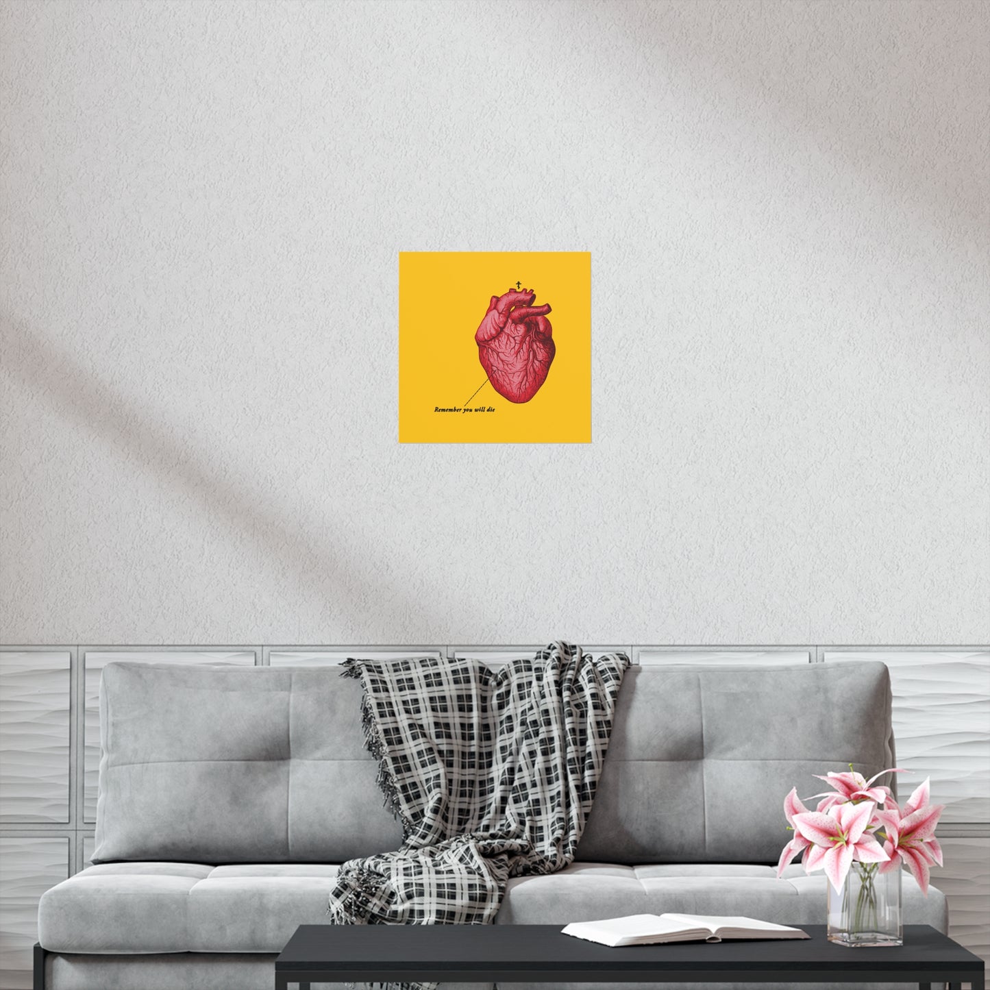 A gray sofa with a plaid throw, a pink vase, and the "Remember You Will Die" retro heart art poster featuring an Orthodox Cross prompt reflection—a quiet moment of repentance, as if whispering, “save me O Lord.”.