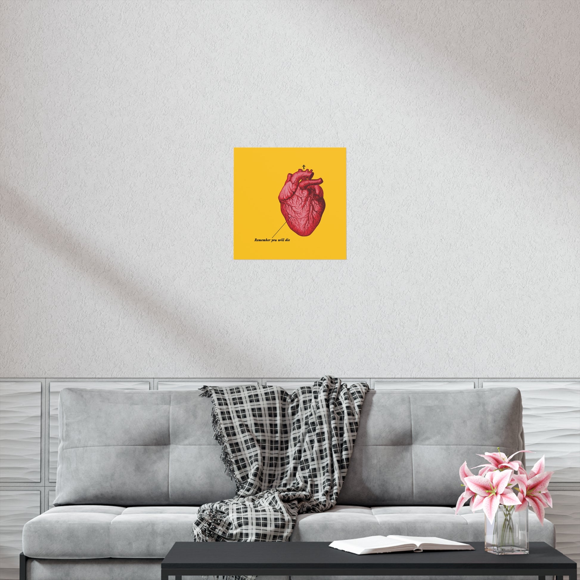 A gray sofa with a plaid throw, a pink vase, and the "Remember You Will Die" retro heart art poster featuring an Orthodox Cross prompt reflection—a quiet moment of repentance, as if whispering, “save me O Lord.”.