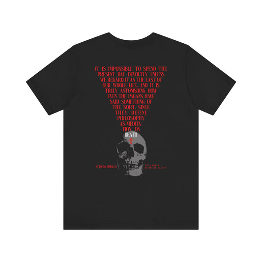 Black "It is Impossible to Spend the Present Day No. 1" Orthodox Christian t-shirt features a back print: red inverted triangle text above a white skull, inspired by St John Climacus’ The Ladder—a bold meditation on death.