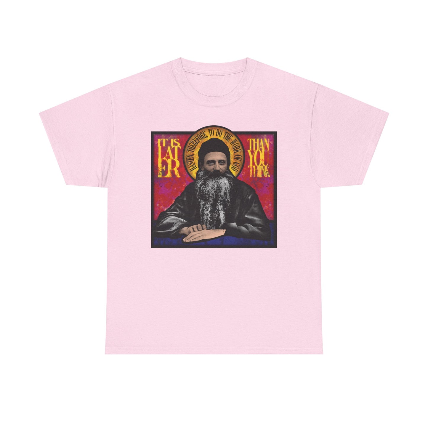 Light pink midweight cotton unisex t-shirt featuring a stained glass icon-style image of Fr. Seraphim Rose and the message: "It Is Later Than You Think"—a subtle prompt to reflect on salvation and the Kingdom of Heaven.