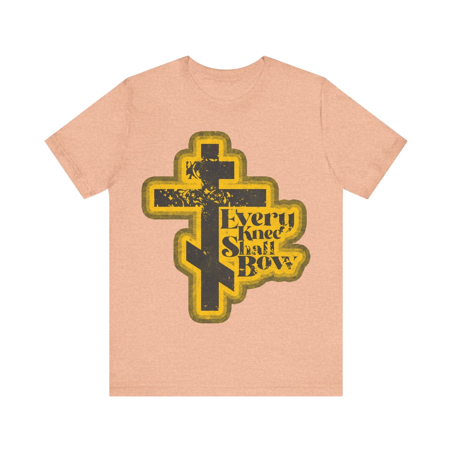 Heather Peach "Every Knee Shall Bow" Orthodox Christian T-shirt features a 70s distressed halftone comic book cross and text inspired by Philippians 2:10-11 & Isaiah 45:23, proclaiming the lordship of Jesus Christ.