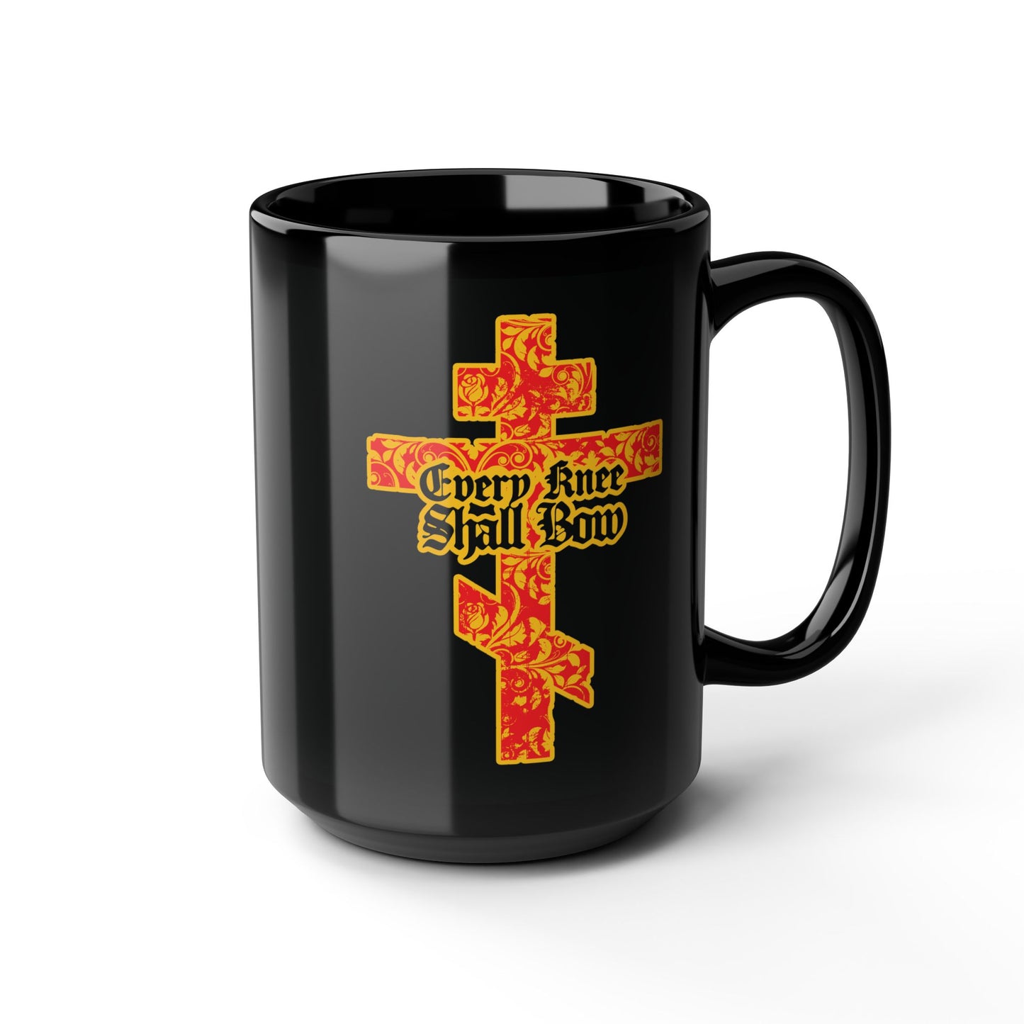 This black mug features a gold and red floral texture Orthodox cross with Gothic lettering and the phrase "Every Knee Shall Bow," inspired by Isaiah 45:22-24 and Phil 2:7-11.