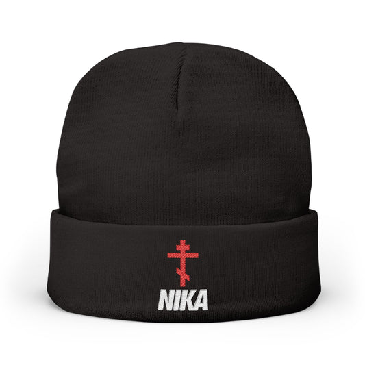 The NIKA Red Embroidered Orthodox Cross Knit Beanie is black, featuring an athletic Orthodox cross and white NIKA Christogram on the front—a unique NIKE logo mashup with Orthodox Christian iconography.