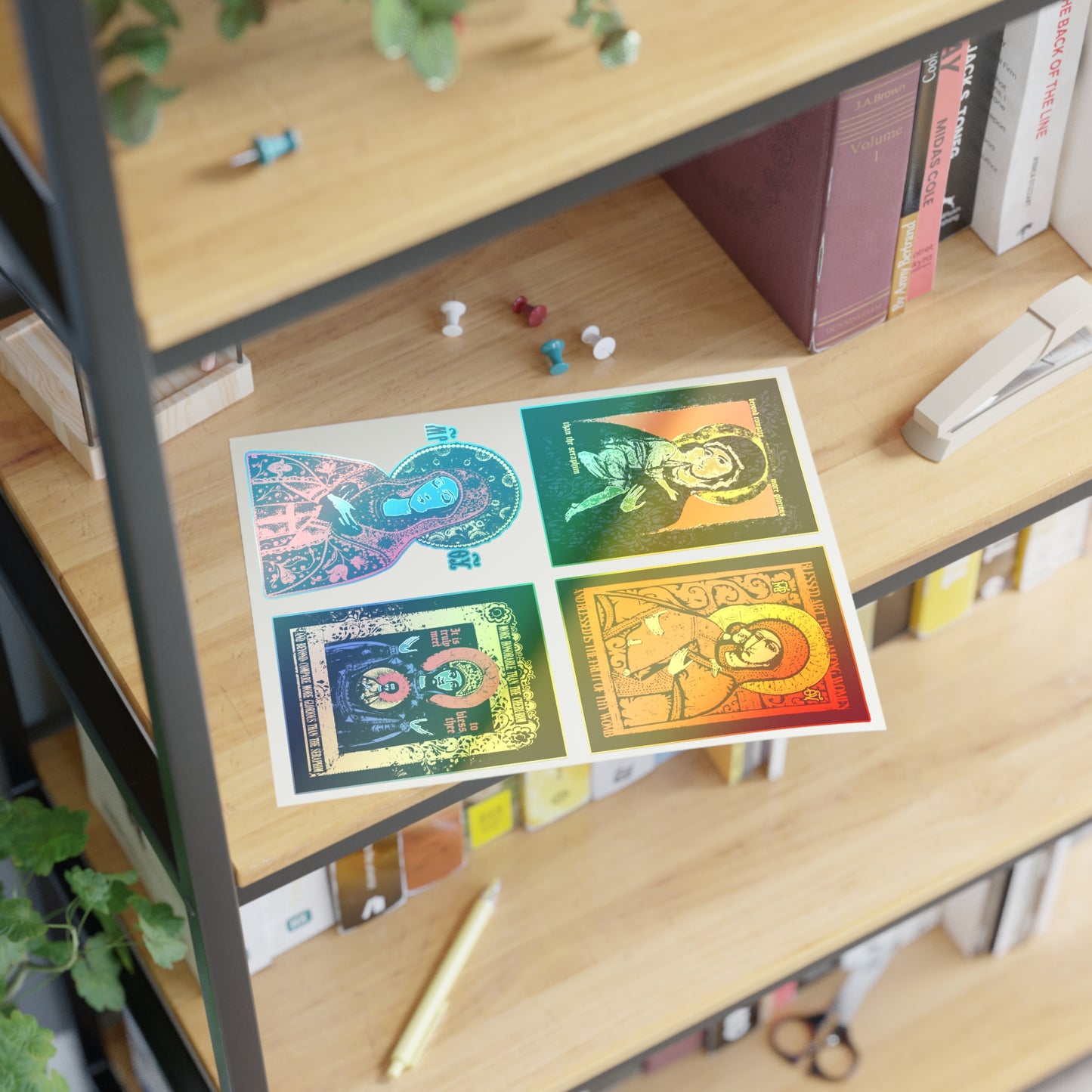 A wooden bookshelf holds books, a stapler, push pins, and a postcard with four colorful portraits. Green plants and a Remembrance of Death Theotokos IconoGraphic Sticker Collection No. 1 ("Vladimir Icon Design") give the shelf unique character.