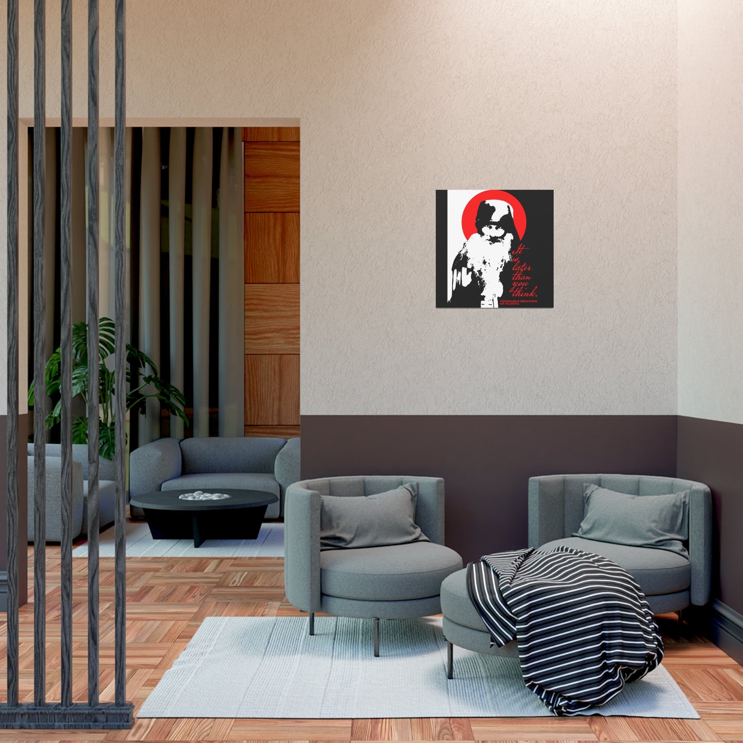 A modern lounge features two gray armchairs, a round table, and a striped blanket. In the background, Remembrance of Death "It's Later Than You Think | Fr Seraphim Rose" poster inspires thoughts of Orthodox faith and gentle spiritual discipline.