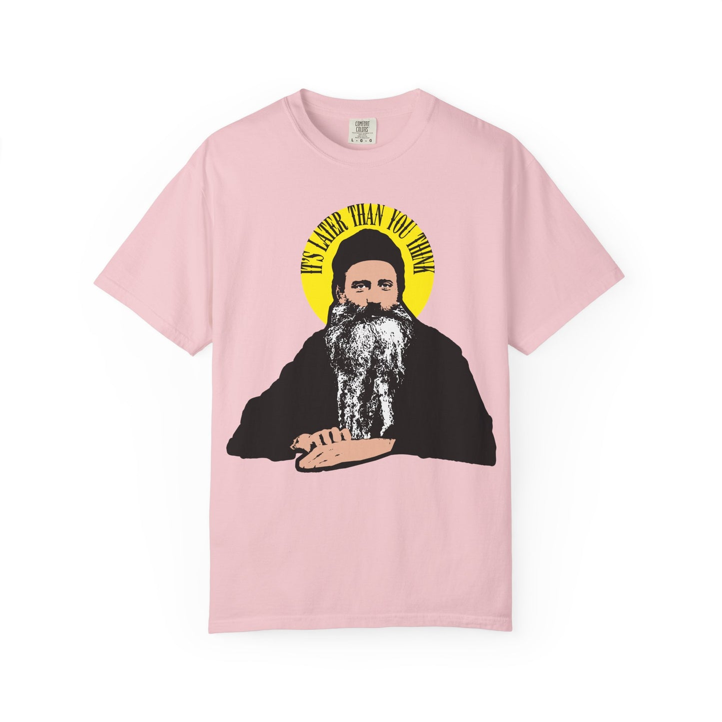 Blossom tee features a graphic of a modern Orthodox saint with yellow "It's Later Than You Think" text in a halo—a bold nod to Fr. Seraphim Rose. Heavyweight cotton unisex fit, inspired by American Orthodox spirituality.
