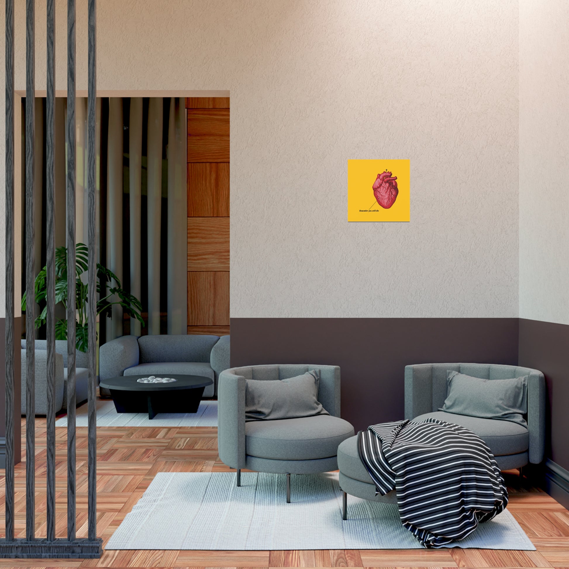 Modern lounge with gray chairs, black table, striped blanket, and the "Remember You Will Die" Retro Medical Textbook Heart Design Christian Art Poster—an inspiring, tranquil retreat.