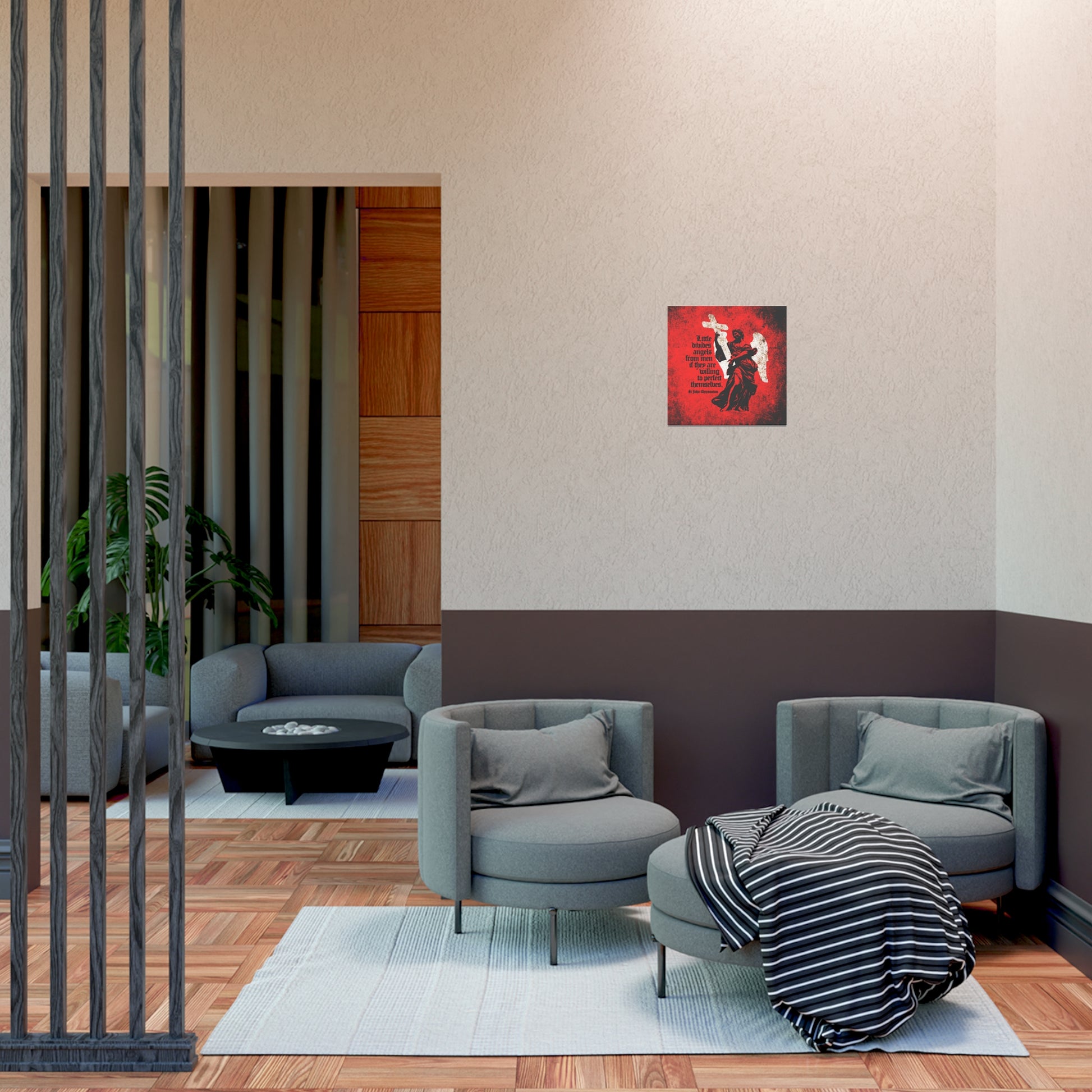 Modern lounge with two gray chairs, a round ottoman, striped throw, and "Little Divides Angels from Men" Christian art poster on a beige wall—creating a serene space for reflection and looking unto Jesus.