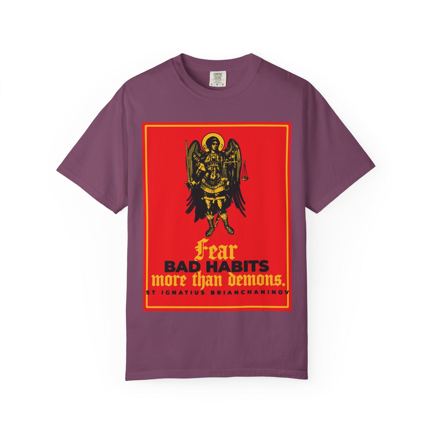 Berry-colored heavyweight cotton unisex tee featuring an icono-graphic of Archangel Michael and the bold message: “Fear Bad Habits More Than Demons,” inspired by St Ignatius Brianchaninov—a striking tribute to the Orthodox spiritual battle between moral freedom and daily temptations.