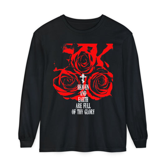 The "Heaven and Earth Are Full of Thy Glory" long-sleeve shirt by Remembrance of Death features three red roses, a white cross, and the hymn text in Western typography—honoring the Divine Liturgy of St. John Chrysostom.