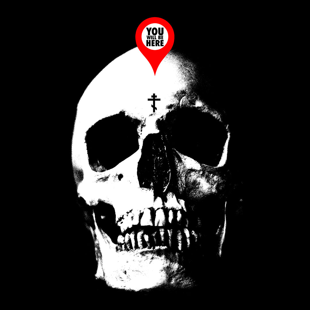 The You Will Be Here Maps Marker on Skull Design Orthodox Christian T-Shirt features a skull with a cross and a red marker above it that states "YOU WILL BE HERE," reminding us of death in the spirit of St Ignatius Brianchaninov.
