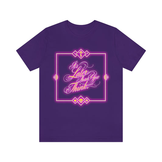 Team Purple T-shirt featuring a glowing neon cursive design that reads Its Later Than You Think by Fr. Seraphim Rose, accented with geometric shapes.
