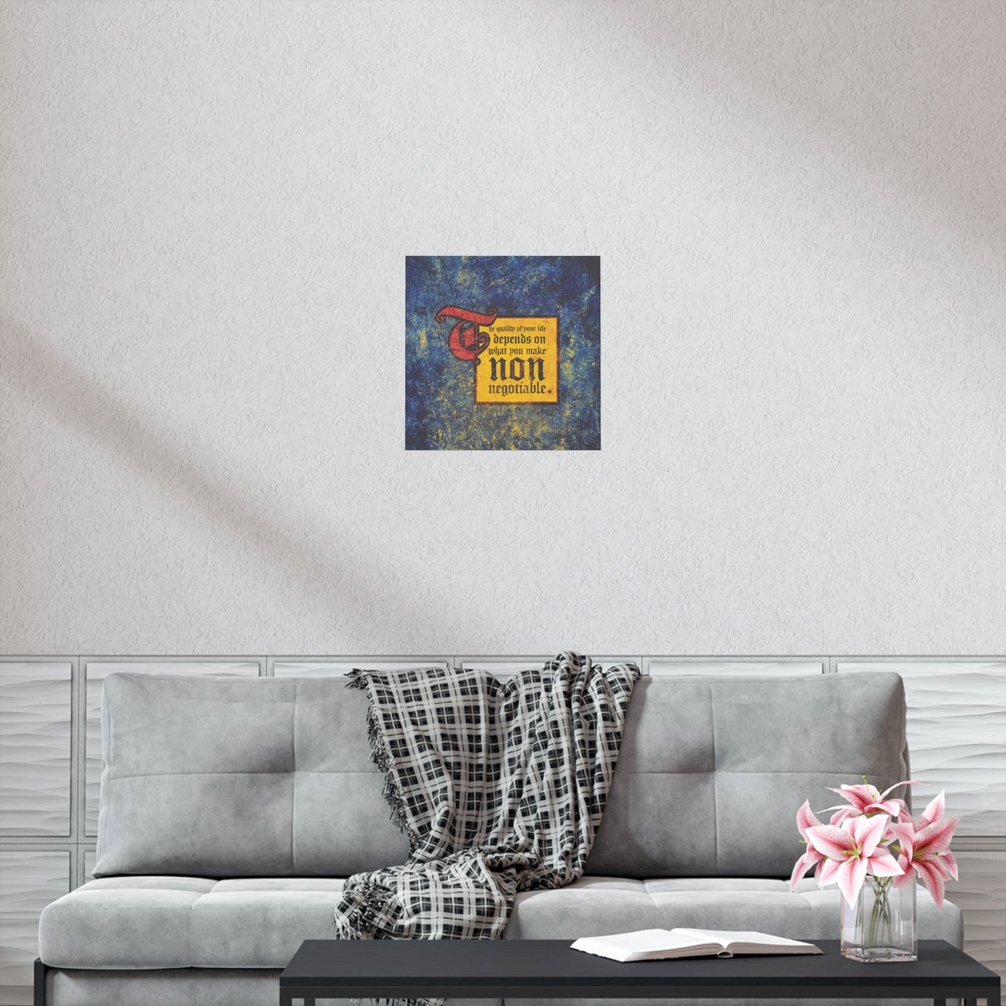A gray sofa with a plaid blanket, pink flowers, and the "Quality of Your Life Depends on What You Make Non-Negotiable" Orthodox Christian art poster creates a modern living room where comfort meets motivation.