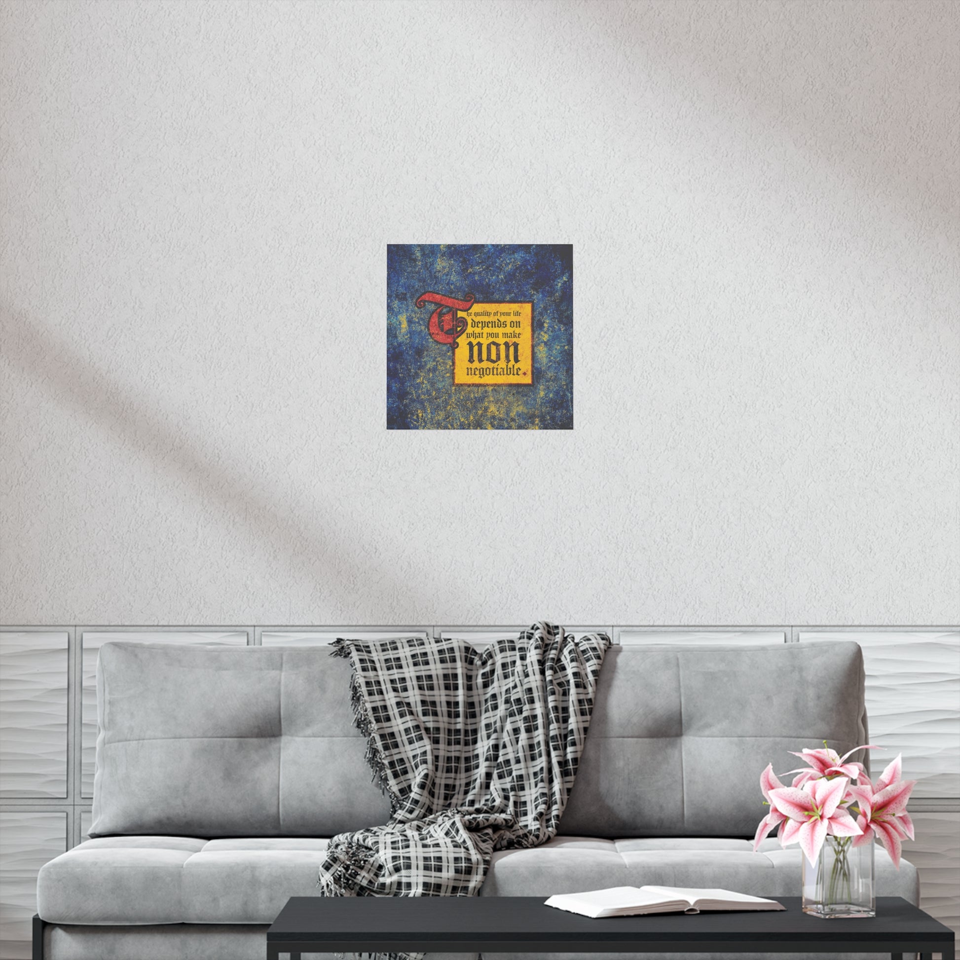 A gray sofa with a plaid blanket, pink flowers, and the "Quality of Your Life Depends on What You Make Non-Negotiable" Orthodox Christian art poster creates a modern living room where comfort meets motivation.