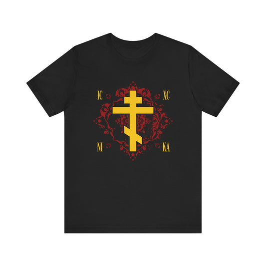 Black lightweight cotton unisex t-shirt showcasing the ICXC NIKA yellow Orthodox Cross on an ornate red background, highlighted with gold religious lettering inspired by St. Kosmas Aitolos—symbolizing the grace of sonship and proclaiming "Jesus Christ Conquers.