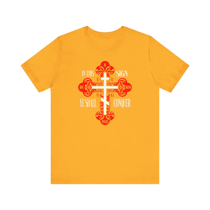 Gold unisex tee featuring the ornate Orthodox Holy Cross (ICXC NIKA) and the phrase "In This Sign Ye Shall Conquer"—a striking Christian symbol of faith and victory.