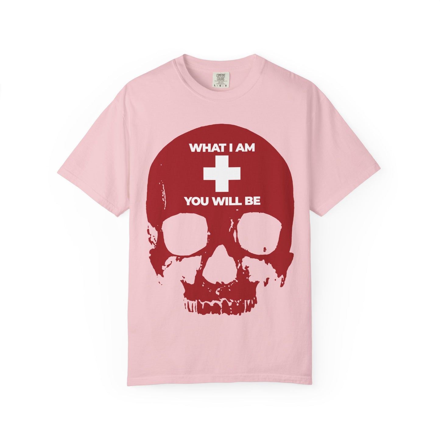Blossom-colored heavyweight cotton tee featuring a striking white cross over a red skull and the bold text "WHAT I AM + YOU WILL BE"—a powerful memento mori inspired by Ecclesiastes and Orthodox Christian tradition.