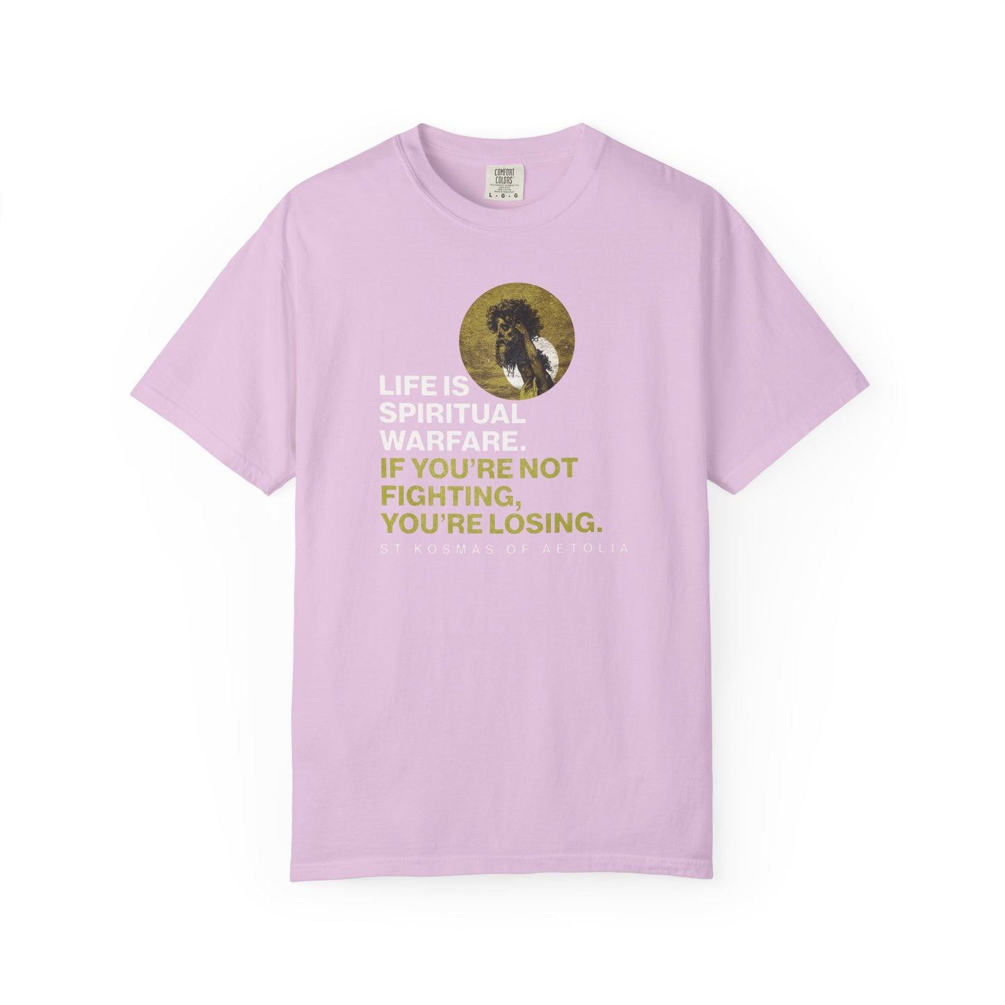 Orchid heavyweight cotton tee featuring "Life is Spiritual Warfare" with a lion image, inspired by St. Kosmas of Aetolia, David & Goliath, and Orthodox themes. "If you're not fighting, you're losing.