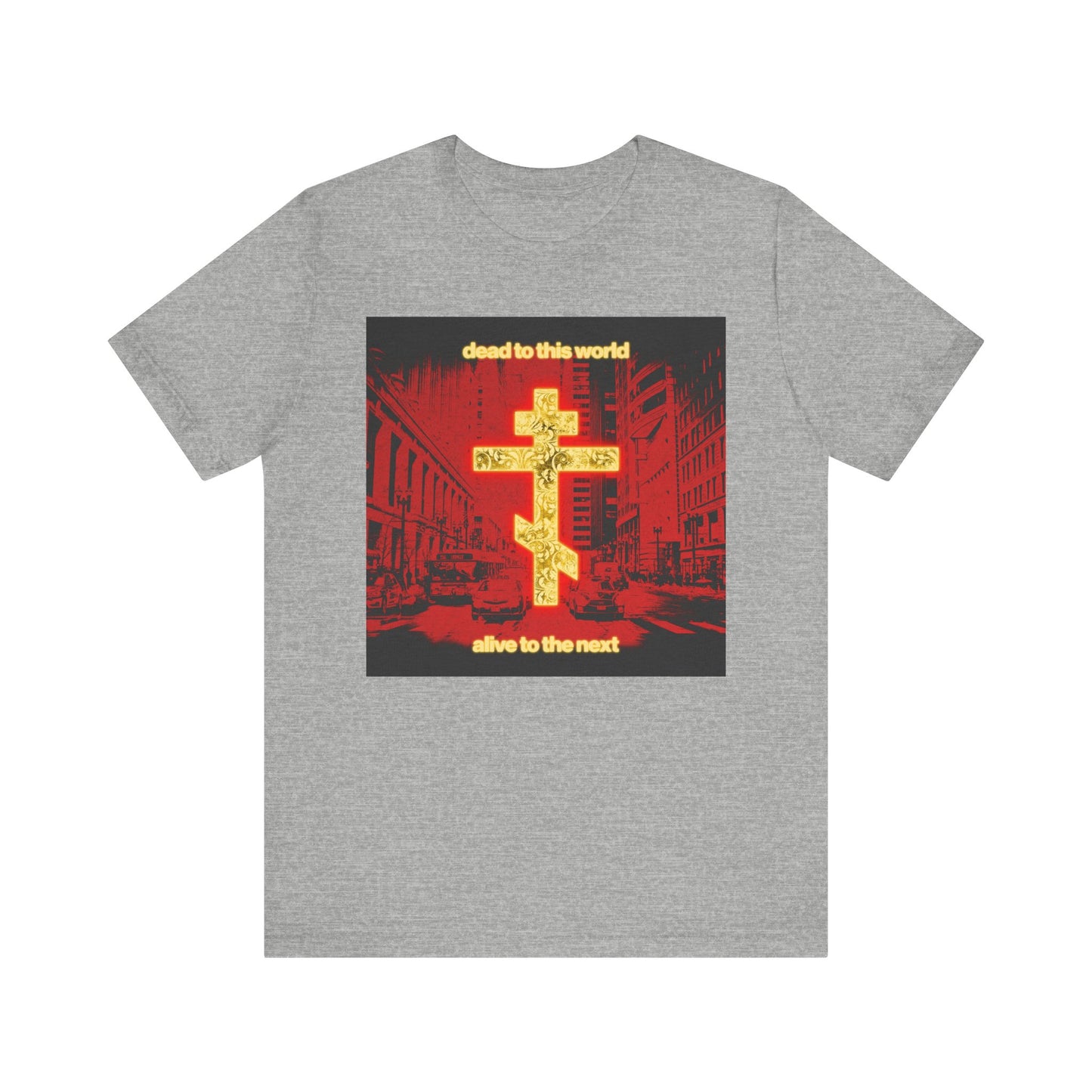 Athletic Heather unisex tee featuring a glowing gold cross over a red cityscape, with “Dead to This World Alive to the Next”—Orthodox Christian design inspired by St. Ignatius Brianchaninov. Lightweight cotton.