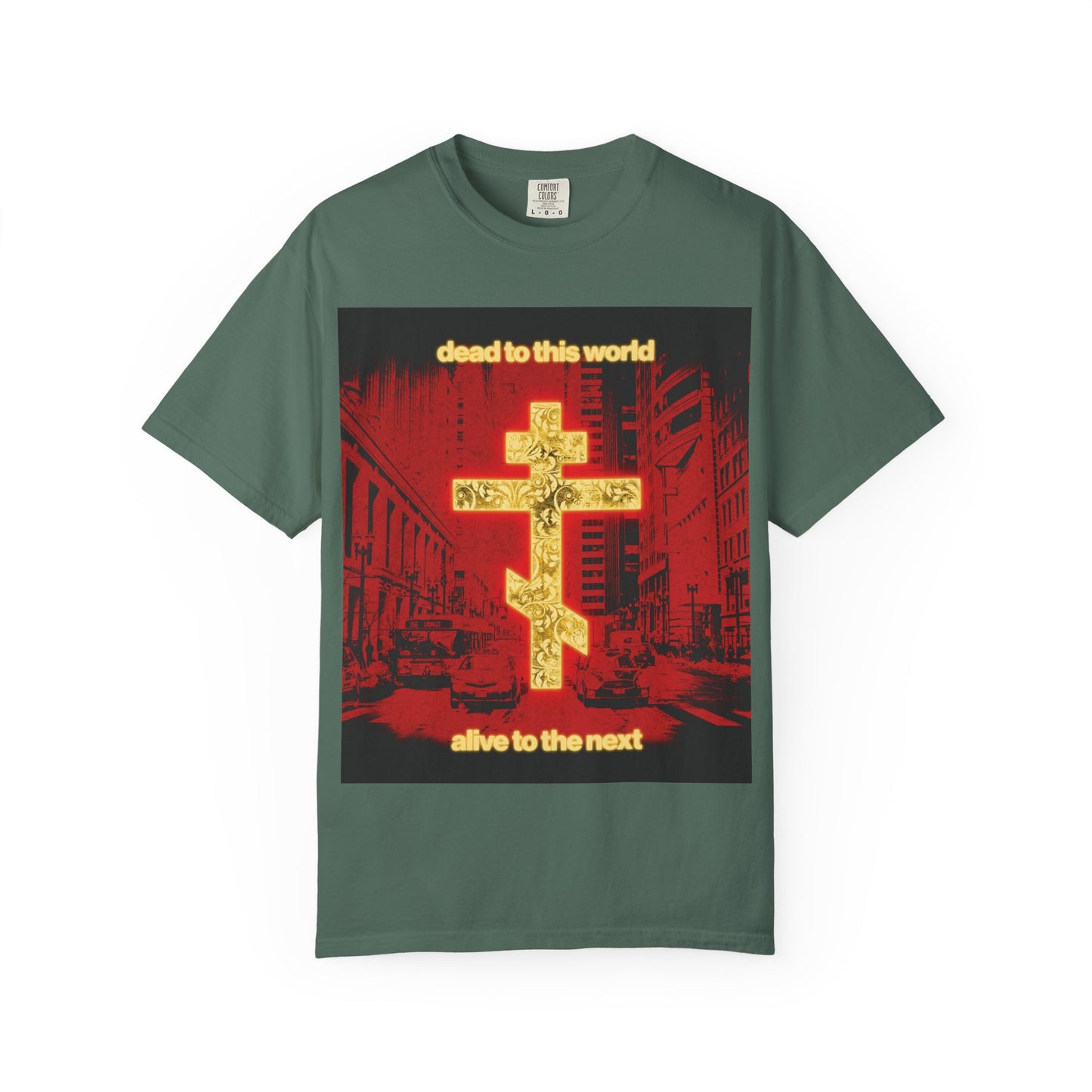 Blue Spruce “Dead to This World Alive to the Next” Orthodox Christian heavyweight cotton unisex tee featuring a glowing gold cross, red cityscape background, and text inspired by St. Ignatius’ reflections on death and eternity.