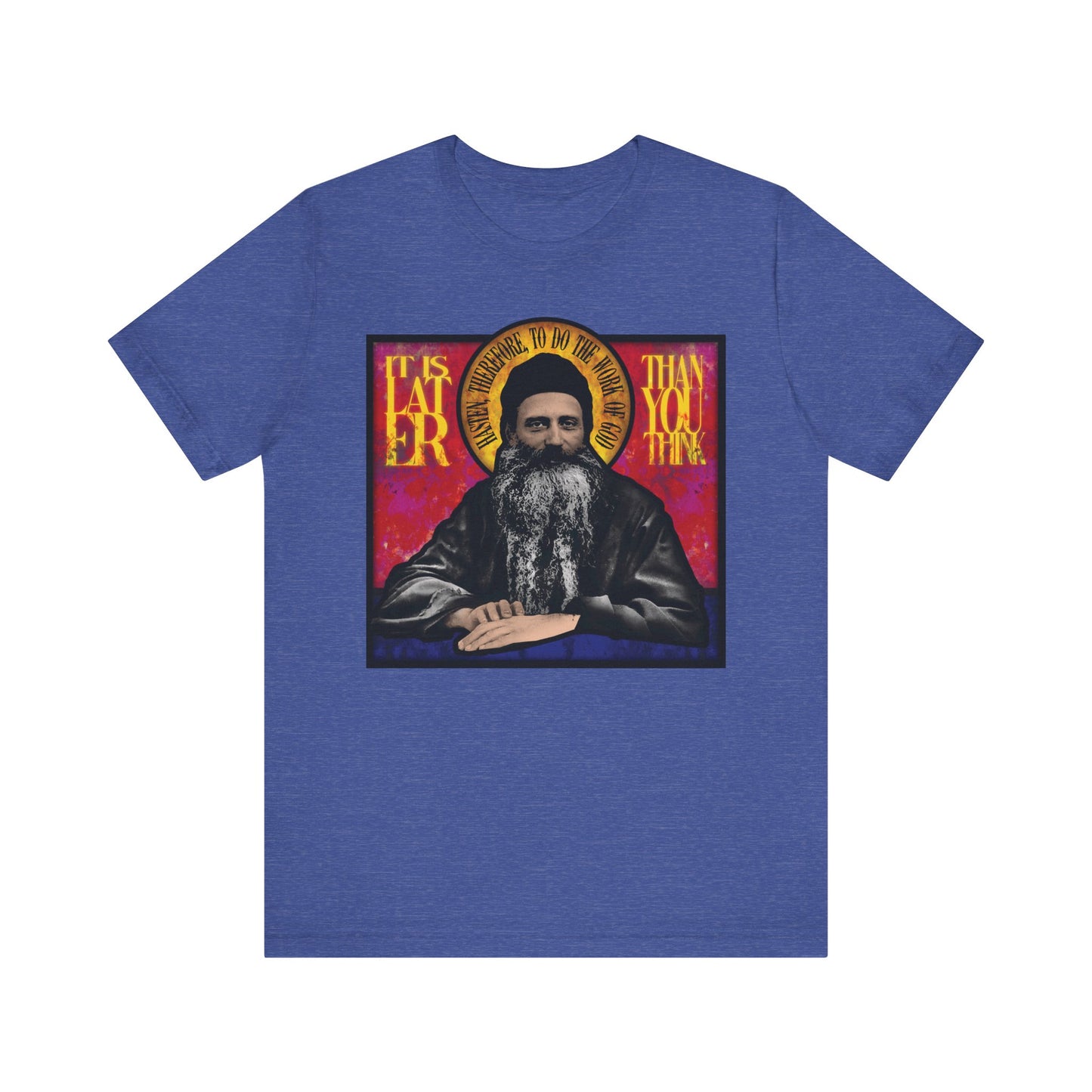 Heather True Royal t-shirt featuring a stained glass design of Fr. Seraphim Rose, with the message "It Is Later Than You Think"—a thoughtful reminder about salvation and reflection. Lightweight cotton, unisex fit.