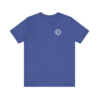 Heather True Royal t-shirt with a small branded front logo and back print, featuring Christian goth flower cross & skull, themed "Dead to this World." Lightweight cotton unisex tee.
