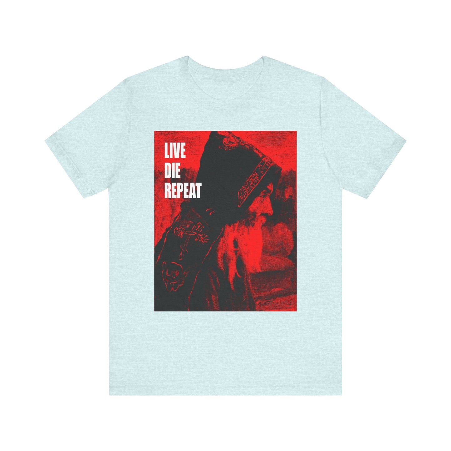 Heather Prism Ice Blue unisex tee featuring Orthodox monk art by Mikhail Nesterov, red "LIVE DIE REPEAT" text, and a hooded figure with skulls—an ascetic design inspired by St Antony the Great's wisdom.