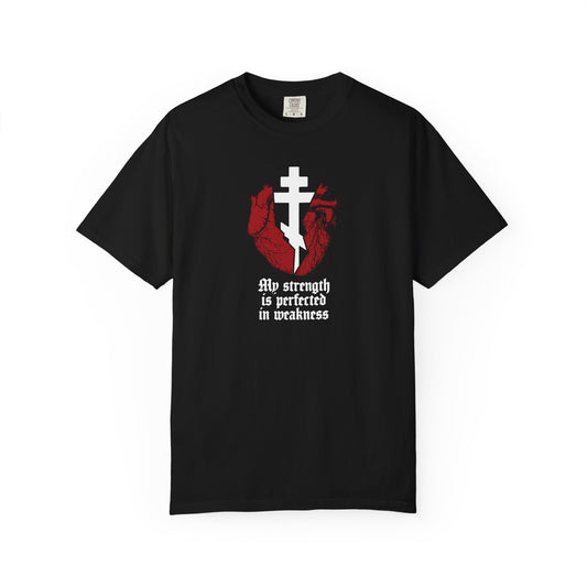 Black "My Strength is Perfected in Weakness (2 Corinthians 12:9)" Orthodox Heavyweight Cotton Unisex Tee featuring a red broken heart with a white cross and bold gothic text—a striking piece of Christian encouragement inspired by finding strength in weakness.