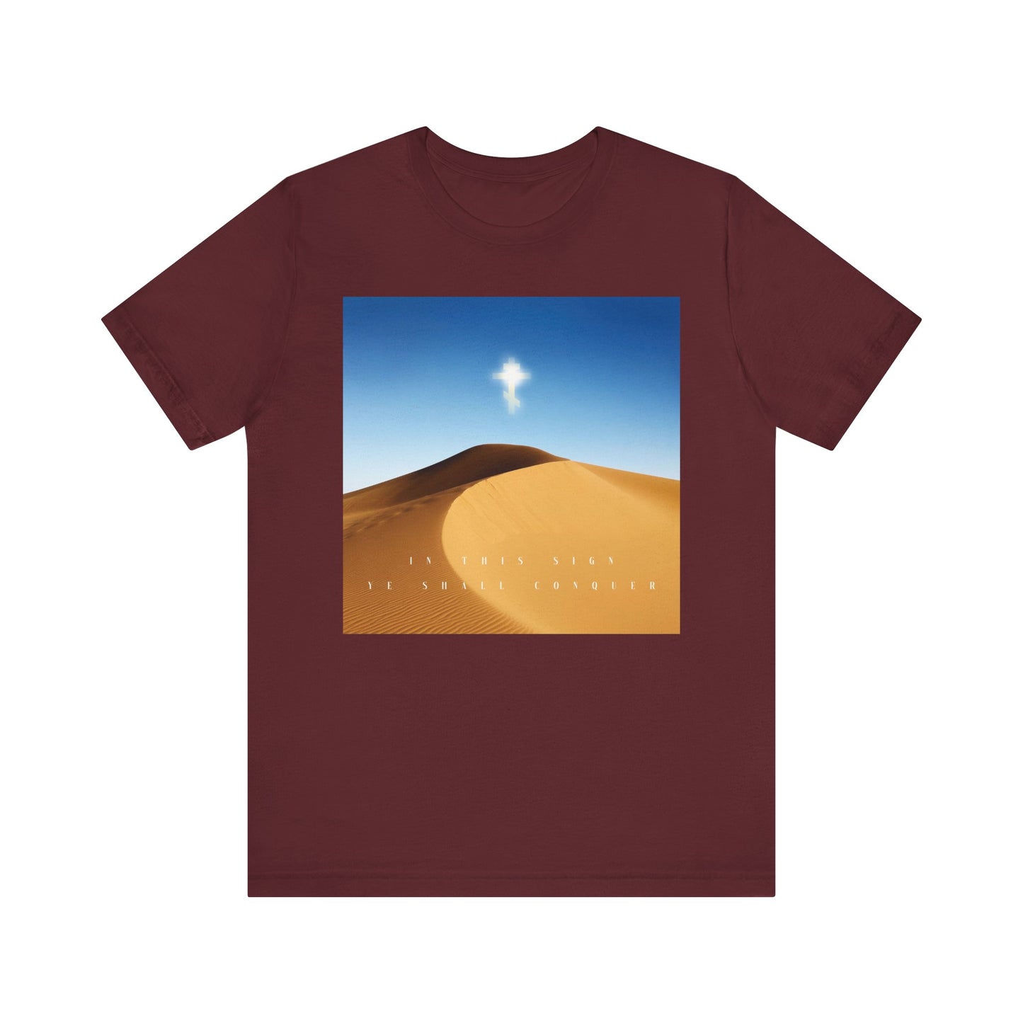 Maroon "In This Sign Ye Shall Conquer" tee featuring a desert sun scene, Cross motif inspired by the Elevation of the Cross, and "The Cross is the Might of Kings" text. Orthodox Christian lightweight cotton unisex shirt.
