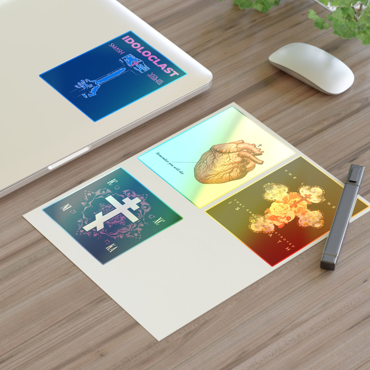 Bestseller Mix No. 2 Four Orthodox Stickers and a pen are by a laptop, with cross and icon designs visible.