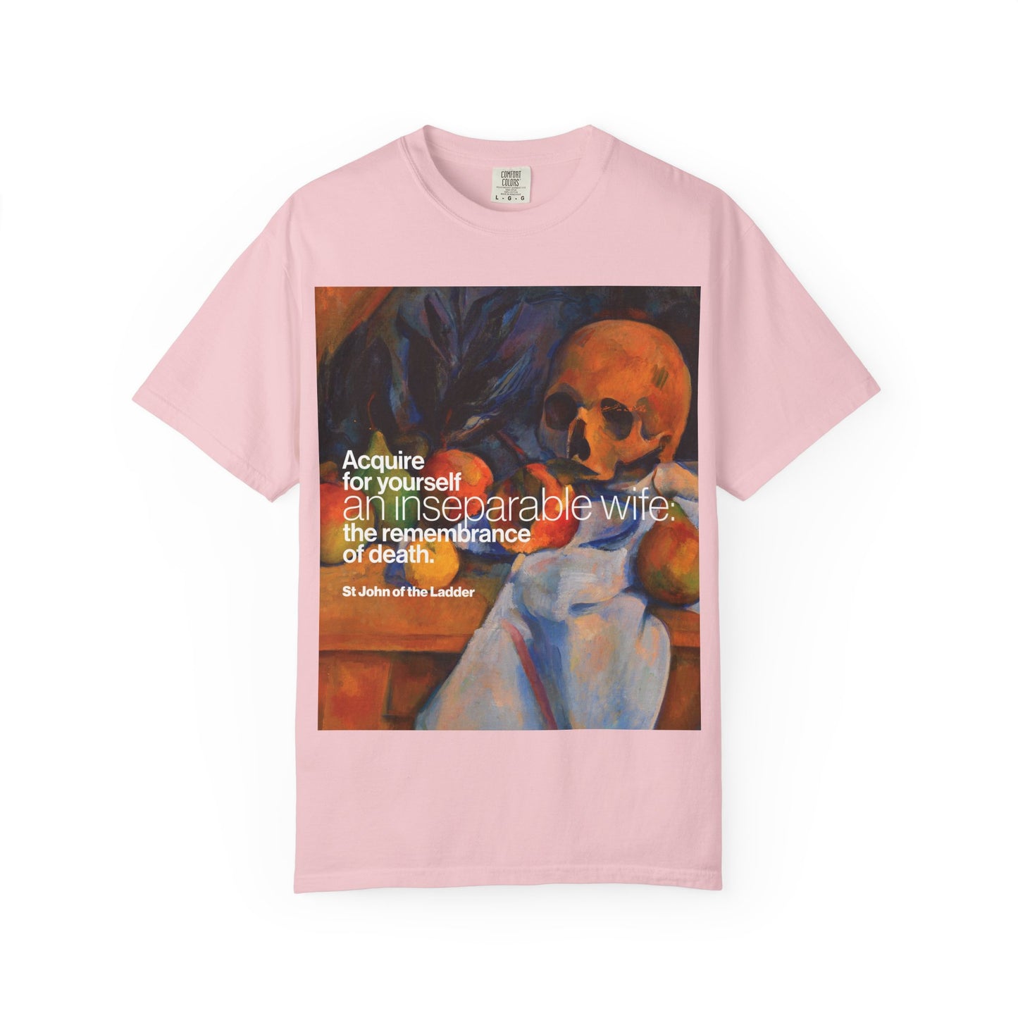 Blossom-colored “Acquire an Inseparable Wife (St John Climacus)” heavyweight cotton unisex t-shirt featuring a Cezanne still life with a skull and a St. John Climacus quote in white and yellow text, reflecting on the remembrance of death.