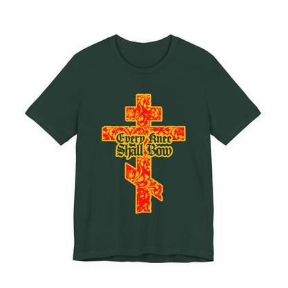 Dark green unisex tee featuring a gold and red floral Orthodox cross with gothic “Every Knee Shall Bow” lettering, inspired by Isaiah 45:22-24 and Philippians 2:7-11.