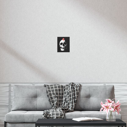 The "You Will Be Here Maps Marker on Skull" Memento Mori Orthodox Christian Art Poster hangs above a gray sofa with a plaid blanket, coffee table, and pink flowers, reminding viewers to reflect on the theme "remember you will die.