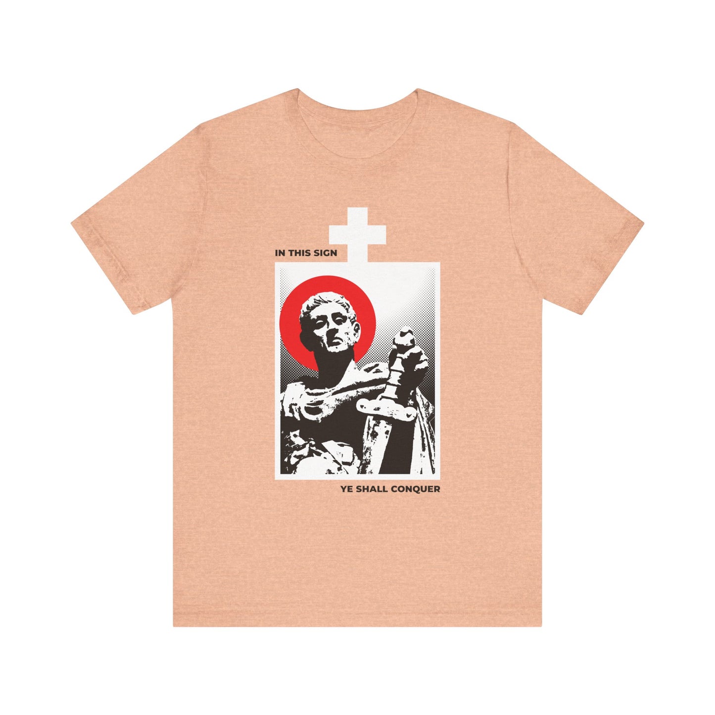 Heather peach unisex t-shirt featuring a striking black and white statue of St Constantine the Great with sword, adorned with a bold red halo, white cross, and the inspiring text: In This Sign Ye Shall Conquer—an empowering reminder to conquer your passions.