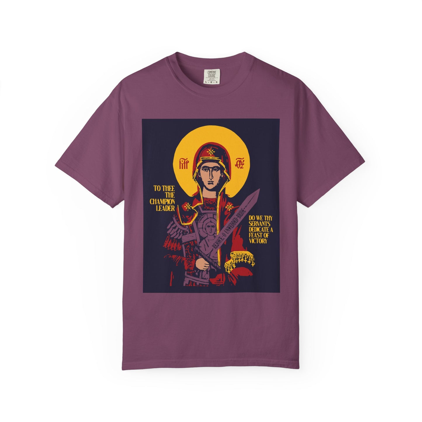 Berry-colored unisex heavyweight cotton t-shirt featuring the "To Thee the Champion Leader" icon-style graphic of the Mother of God Theotokos with sword, angels, and gold-accented shield.
