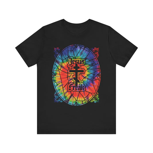 Black Jesus Freak tee featuring a vibrant tie-dye stained glass window design with an Orthodox cross and gothic "Jesus Freak" text at the center, inspired by the passionate spirit of the 70s Jesus Movement and original hippie Christians—a bold nod to its roots.