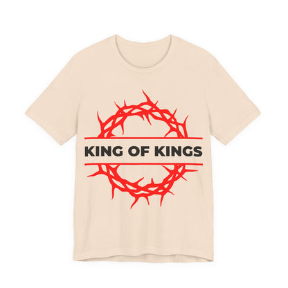 Soft cream unisex cotton tee featuring a red crown of thorns and bold black "KING OF KINGS" text, inspired by Revelation 19:16—the King of Glory. Orthodox Christian design from the "Christ is King" collection.