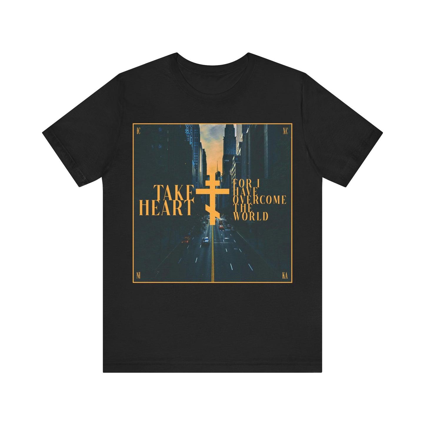 The "Take Heart, For I Have Overcome the World" black cotton t-shirt features a modern city street scene at sunset with a gold cross and uplifting John 16:33 message—an Orthodox Christian reminder to find joy through adversity.