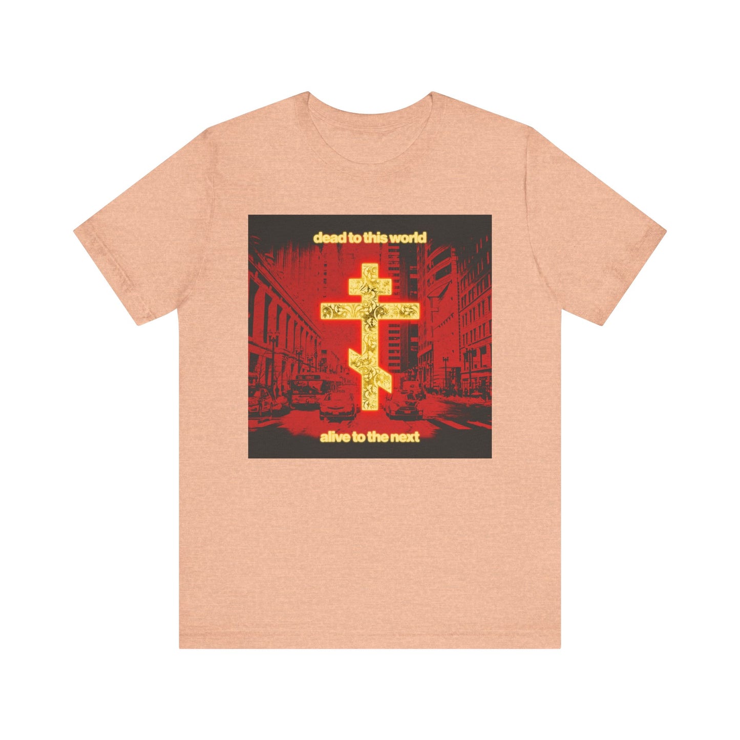 Heather peach Orthodox Christian tee featuring a glowing gold cross and red cityscape, with “Dead to This World Alive to the Next” text—lightweight cotton unisex shirt inspired by St Ignatius Brianchaninov on death and eternity.
