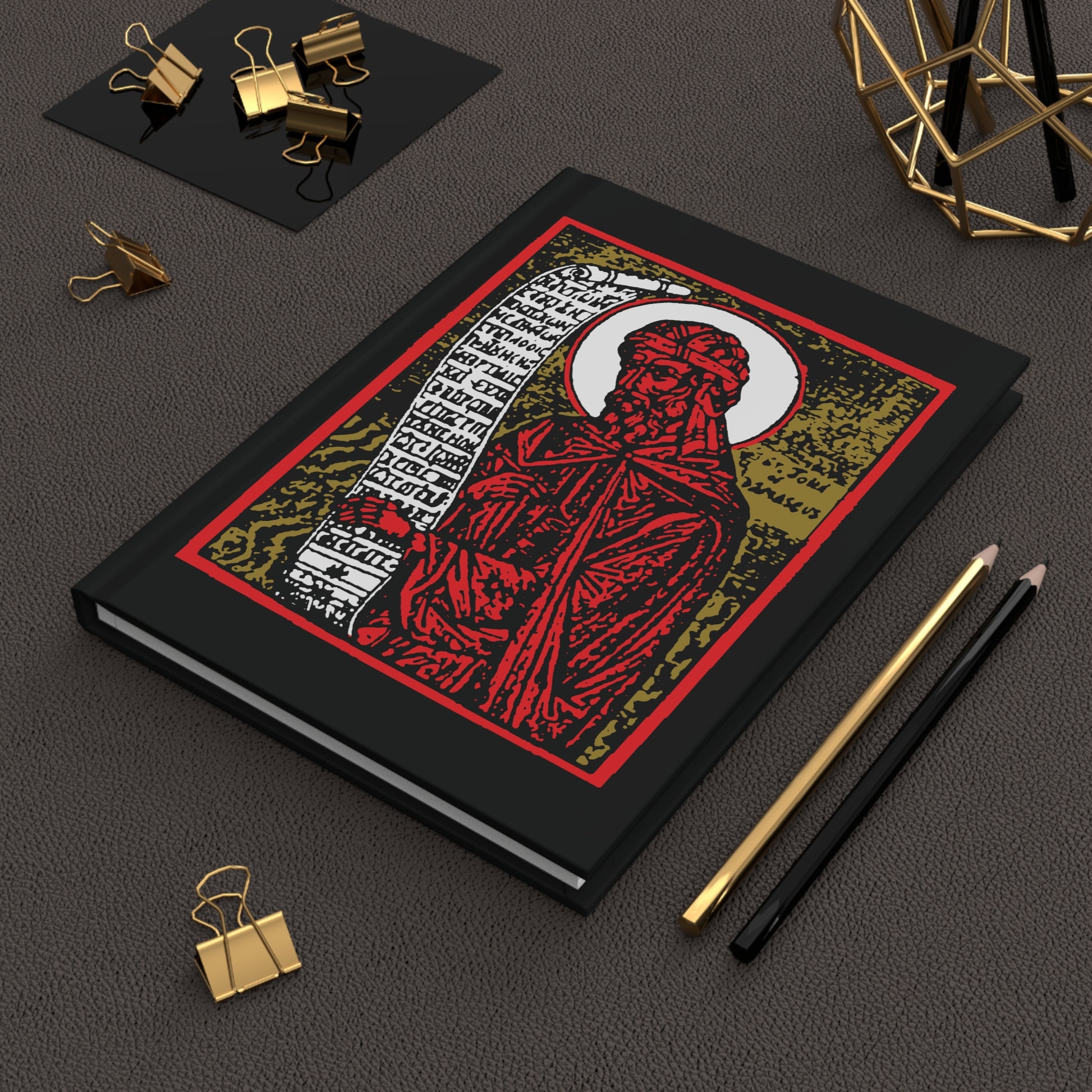 The "St. John of Damascus Icono-Graphic" hardcover journal features a bold red, gold, and black design—perfect for jotting down Orthodox hymns or Stichera for the Dead alongside your favorite desk accessories.